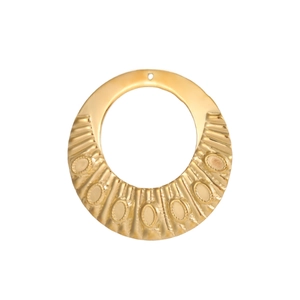 Detailed view of round gold pendant with sunburst texture and embossed details