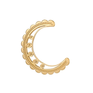 Detailed view of a vintage gold crescent moon clip-on earring with intricate filigree details