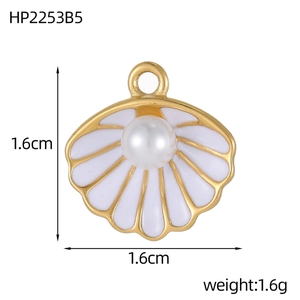 Detail of a gold heart shell pendant with white enamel and pearl center, size 1.6cm