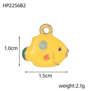 Macro shot of 1.5cm yellow enamel fish pendant with golden ring and multi-color details
