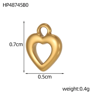 Macro view of gold heart pendant with dimensions 0.7cm by 0.5cm and 0.4g weight