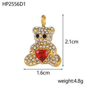 Detailed view of a gold bear pendant with white rhinestones and a red heart gemstone