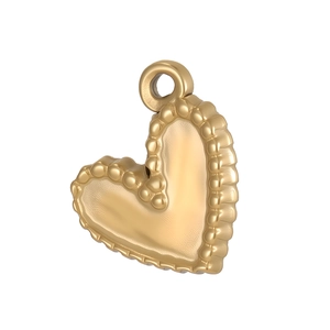 Detailed view of a gold heart pendant with beaded edges and polished metallic finish