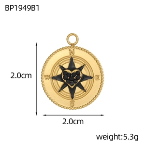 Detail of a 2cm golden stainless steel compass pendant with a black crystal heart core