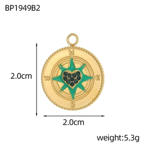 Macro view of 2cm golden compass star heart pendant with green enamel and lobster clasp