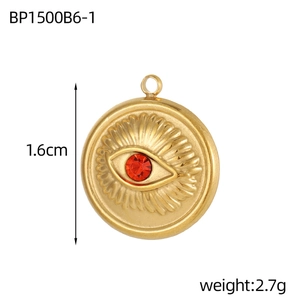 Golden Evil Eye pendant with red stone inlay and textured eyelashes on white background