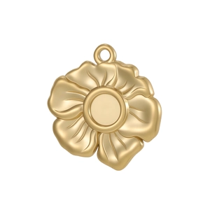 Macro view of golden floral pendant base with a circular recessed setting for DIY jewelry