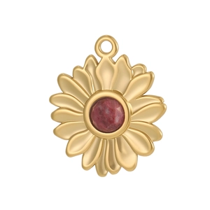 Gros plan d'un pendentif tournesol doré avec une pierre précieuse rouge au centre