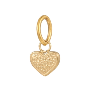 Detailed view of a golden heart pendant with beaded texture and large metal ring