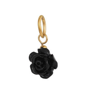 Macro detail of elegant black resin rose pendant with a polished gold metallic hanging ring