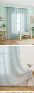 Detail of light blue sheer curtain showing white starburst patterns and fabric texture