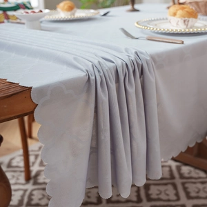 Minimalist jacquard tablecloth with scalloped edges and textured floral patterns