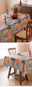 Close-up detail of bohemian tablecloth featuring geometric patterns and scalloped edges