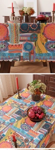 Detail of bohemian tablecloth featuring vibrant ethnic patterns and laser-cut wavy edges