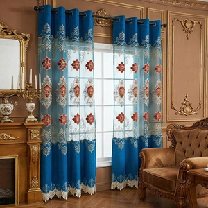 Elegant peacock blue European embroidered curtains with sheer lace and tassels in a living room