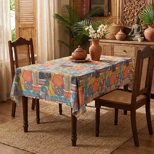 Ethnic bohemian style rectangular tablecloth with vibrant geometric patterns on wooden table