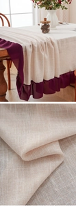 Detail of beige linen-textured tablecloth featuring deep purple chiffon ruffle edges