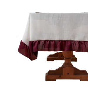 Linen texture tablecloth with burgundy pleated ruffle edge on a vintage wooden table