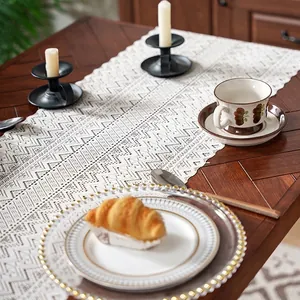 Beige hollow crochet table runner with lace tassels and geometric patterns for home decor