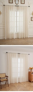 Detail of cream lace curtain featuring delicate floral patterns and scalloped edges