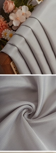 Macro detail of high-quality grey thick fabric with a distinct herringbone weave texture