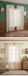 Detail of cream lace curtain featuring intricate crochet patterns and a scalloped edge finish