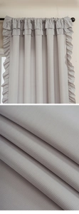 Detail of light grey ruffles and herringbone weave texture on French style thick curtain
