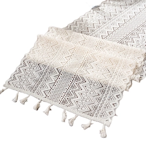 Bohemian cream lace table runner with geometric hollow patterns and fringe tassels
