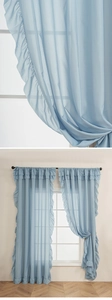 Close-up of light blue sheer curtains featuring romantic ruffled edges and airy texture