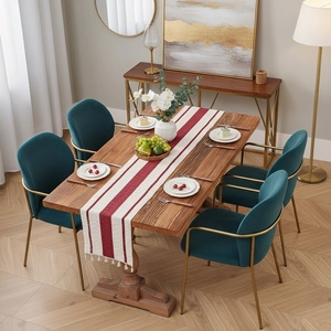 Elegant hemp dining table runner with red stripes and white tassels on a walnut table