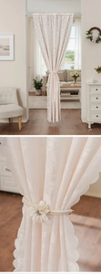 Detail of pink lace door curtain showing intricate rose jacquard and wavy scalloped edges