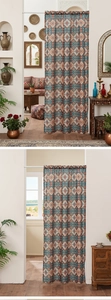 Detail of bohemian door curtain with blue and orange mandala patterns in home setting