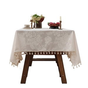 American vintage floral tablecloth with tassels on elegant wooden dining table