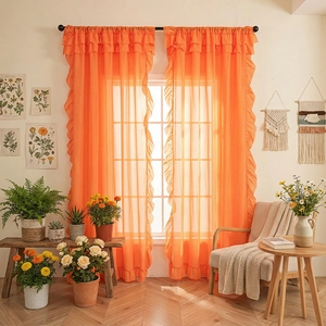 Bright orange sheer ruffle curtains with rod pocket design for a warm interior aesthetic