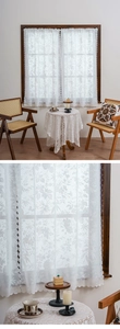 Close-up of white floral lace curtain detail with delicate scalloped edges and pattern