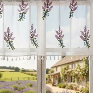 Lace cafe curtain with lavender embroidery and white tassels in a rustic farmhouse style