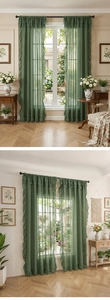 Detail of dark green sheer curtain with ruffles in a cozy American rural living room