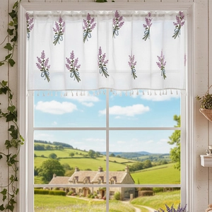 Close-up of lavender flower embroidery on a white lace cafe curtain with delicate tassels