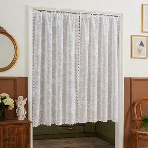 White floral lace door curtain with scalloped edges in a vintage French country style