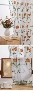 Close-up of tulip embroidery and scalloped lace edge on white sheer floral curtains