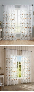 Detail view of white sheer curtain with elegant orange tulip embroidery and wavy green trim