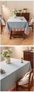 Detail of light blue linen tablecloth featuring elegant pink ruffled edge and thick texture