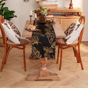 Luxury black table runner with gold feather print and elegant scalloped edges decoration