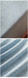 Detail of light blue cotton linen tablecloth fabric with thick woven texture and drape