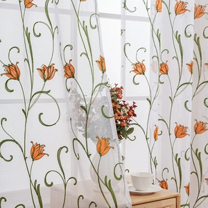 White sheer curtain featuring delicate orange tulip and green vine floral embroidery