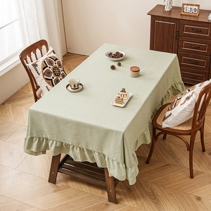 Light green rectangular linen tablecloth featuring elegant ruffled edges for home dining