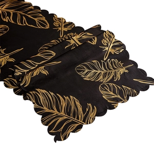Elegant black table runner with golden feather patterns and wavy scalloped edges