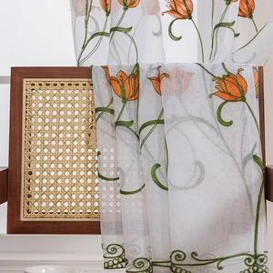 Sheer white floral curtain with orange tulip embroidery and green leaf patterns