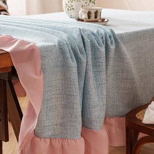 Blue linen textured tablecloth with pink chiffon ruffle edges for a rustic dining look