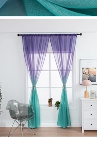 Detailed view of sheer gradient curtain with purple and teal hues and tassel tieback